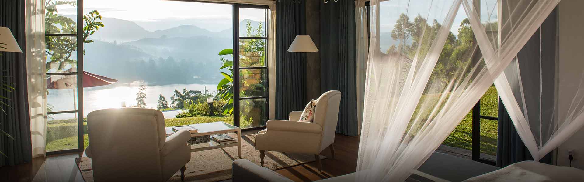 Teardrop Hotels offers a romantic honeymoon suites in Sri Lankan with stunning mountain views and a cozy seating area.
